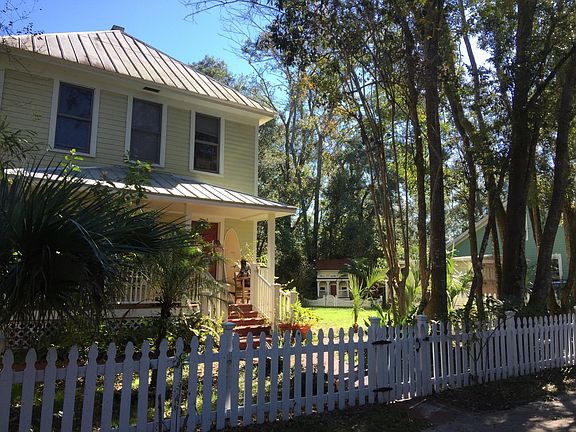 House showing playhouse in the back corner of the fenced yard.