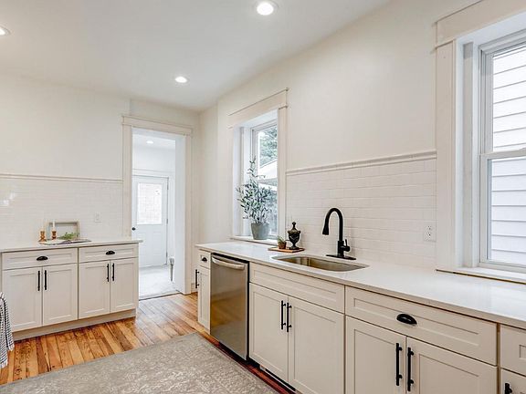 Beautiful designer kitchen with subway backsplash, quartz counters, and stainless steel appliances!