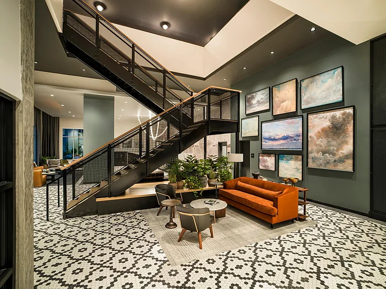 Artful design and layered textures welcome you to Modera Shoreline's lobby, where striking details meet a sense of comfort and community.