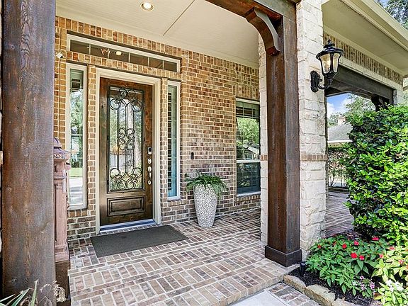 Lovely front porch with wooded beams and classic leaded front door are sure to impress your guests.