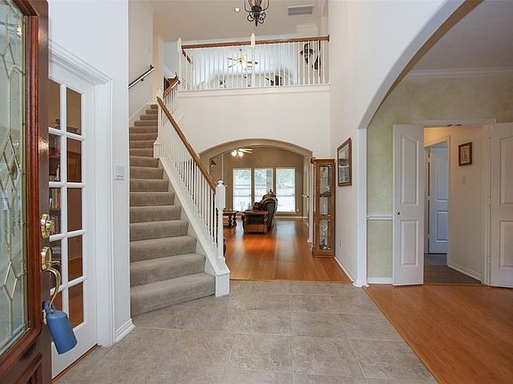 Entry looking towards formal living room with wall of windows.  This home is light and bright with natural light.