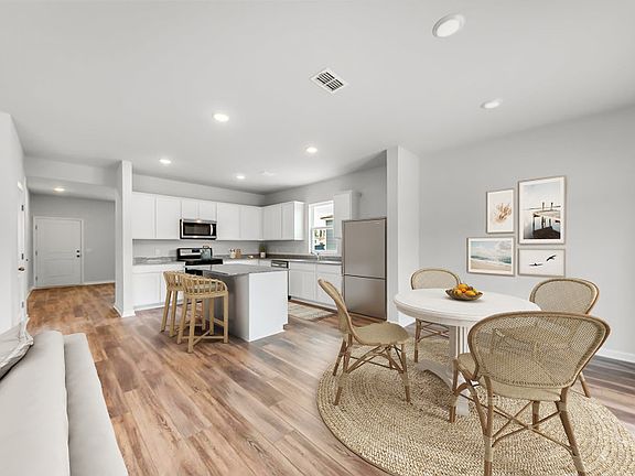 Open floorplan with classic engineered wood flooring connecting the Kitchen, Cafe and Gathering Room