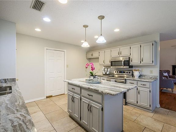 The kitchen is the heart of this home with a big breakfast room and open access to the adjoining family room. A convenient swinging door leads to the dining room.
