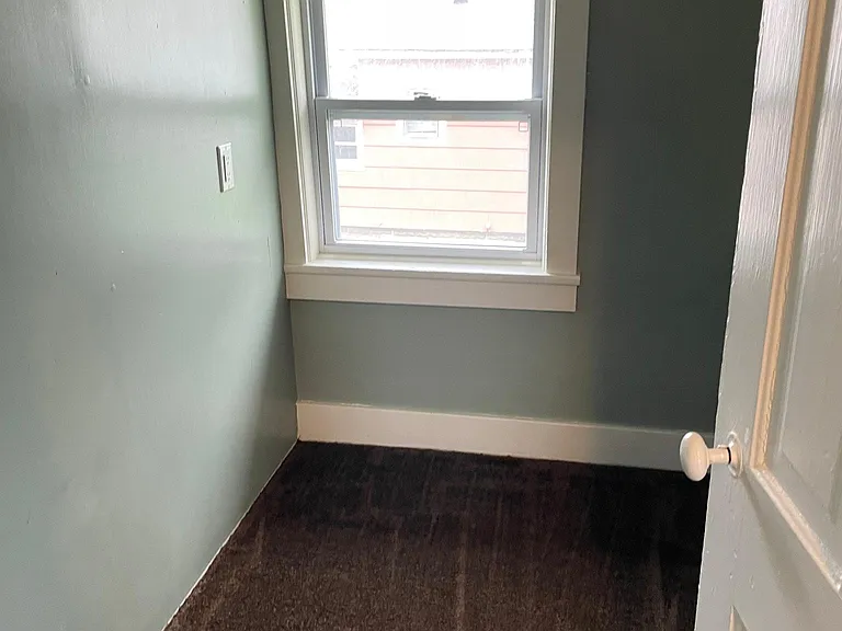 Walk in pantry with shelving on the right side of the closet.