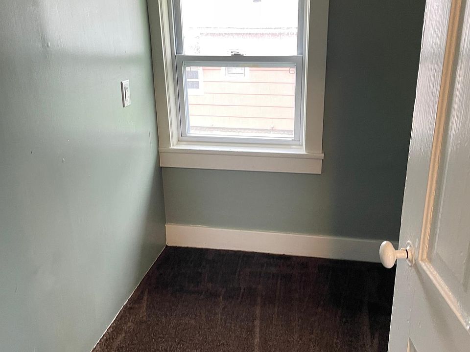 Walk in pantry with shelving on the right side of the closet.
