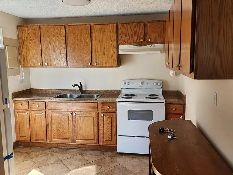 Tiled Kitchen with brand new appliances and touched up cabinets.