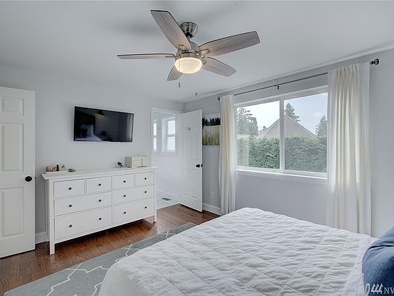 The Master Bedroom offers a large window and ceiling fan together with a private bath.  Cool tones of white and gray create an inviting Ensuite. 