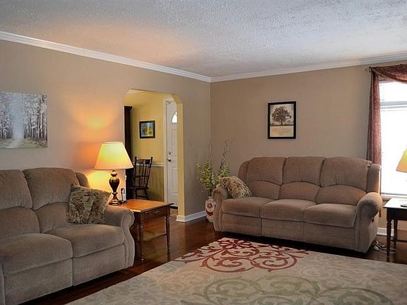 LIVING ROOM:  The living room leads to the dining room, where there is an access door to the covered side porch.