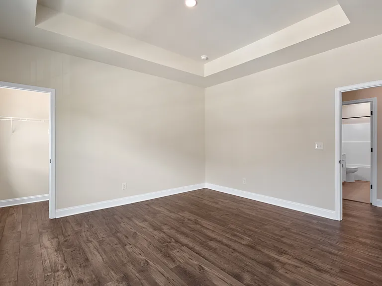 Primary bedroom with 2 walk-in closets