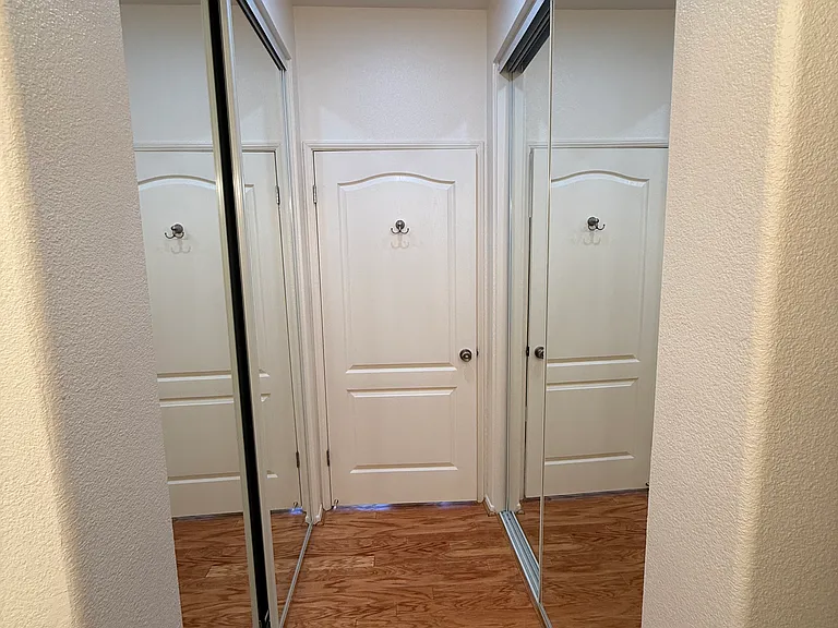 View of Master bedroom closet with mirrors.
