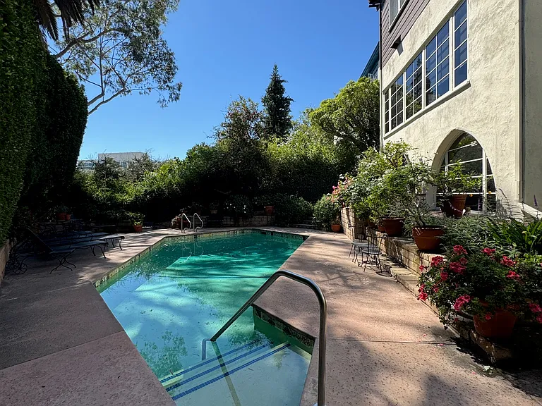 Pool (alternate angle) - pool and patio with flowering plants.