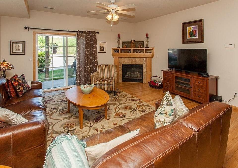 Large open living room with fireplace and patio access