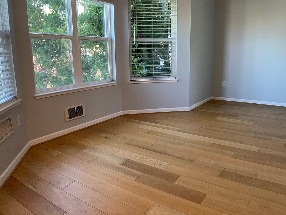 Living room with expansive bay windows and lots of light!