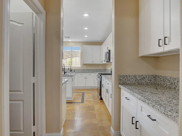 Hallway to downstairs bathroom and kitchen