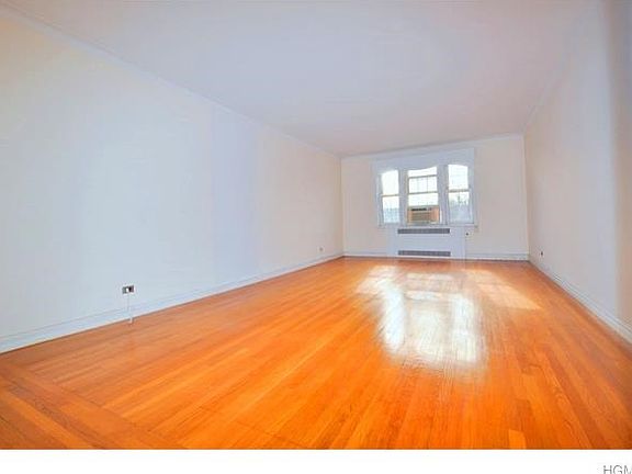 Large sunny living room has southern exposures and hardwood floors.  The room is 23'-0" x 13'-6".