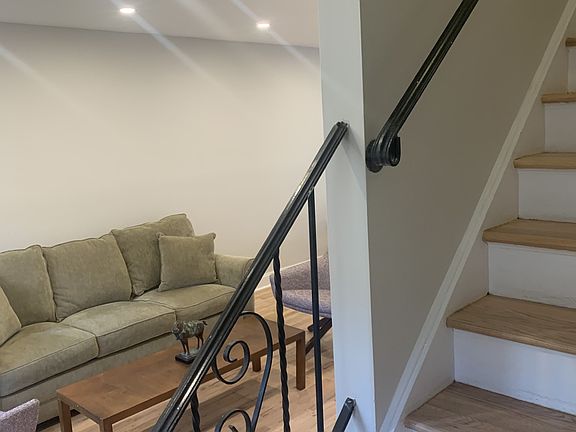A view of the living room from the base of the stairs that lead to the bedrooms.