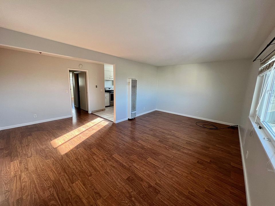 Full living room adjacent to full dining room with huge window--natural light throughout.