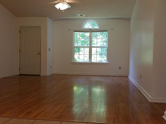 Vaulted great room with wood laminate flooring, ceramic tile