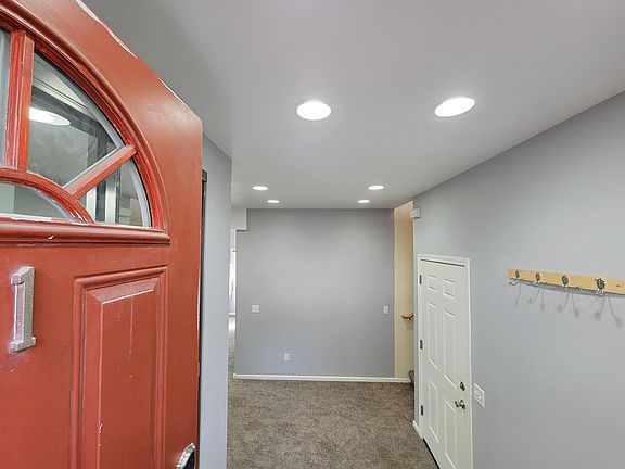 Entry. Garage and stairs to living room on the right.