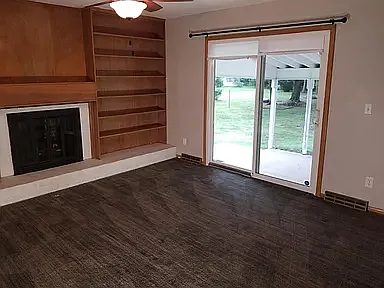 carpeted living room with patio door