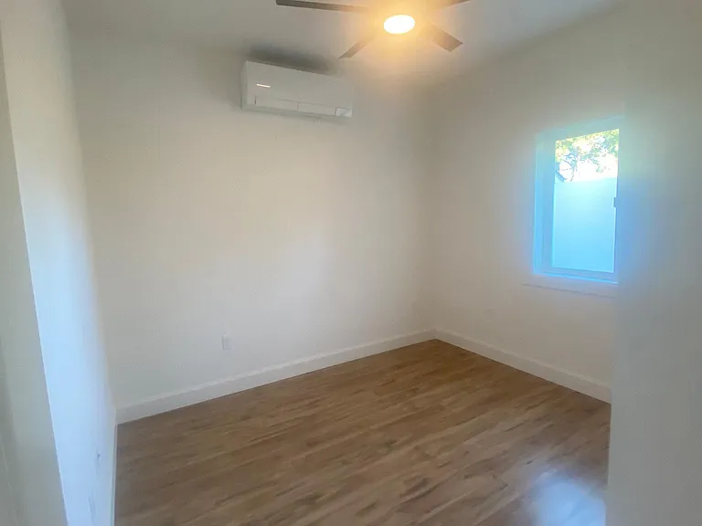 Bedroom two with Mitsubishi mini split and Hinkley ceiling fan