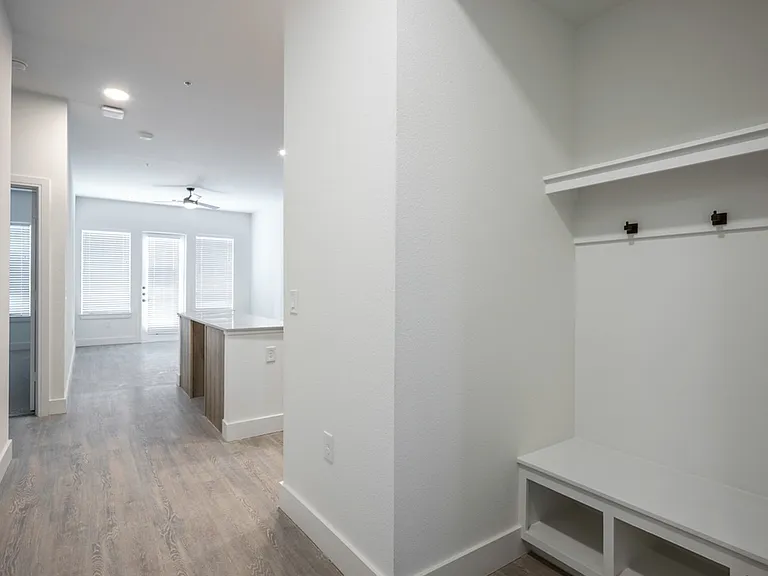 Discover the seamless integration of mudroom nooks, sleek desks, and functional shelves in the Modera Trinity design. Elevate your space with stylish efficiency.