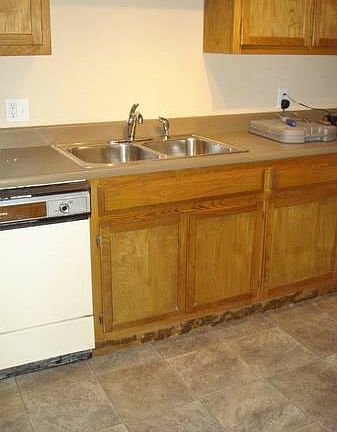 Kitchen with new fridge, gas stove
