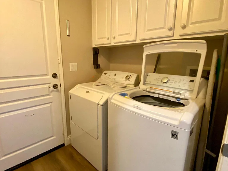 The laundry room is on the ground floor and has good storage cabinets. The door opens to the garage.