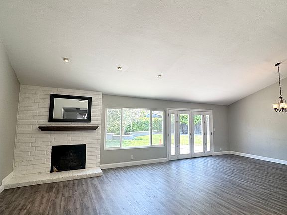 Living room with cathedral ceilings and recessed lighting