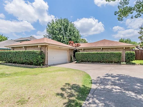 Manicured landscaping greets you on this charming home.