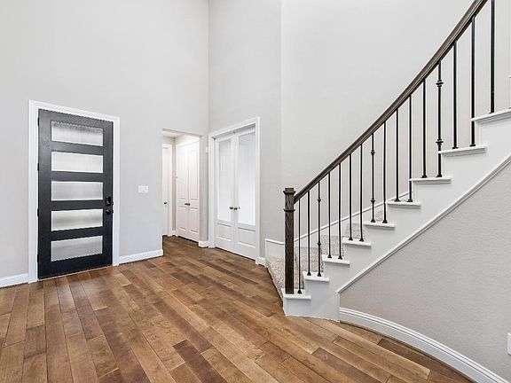 Wood and glass front door and wood flooring