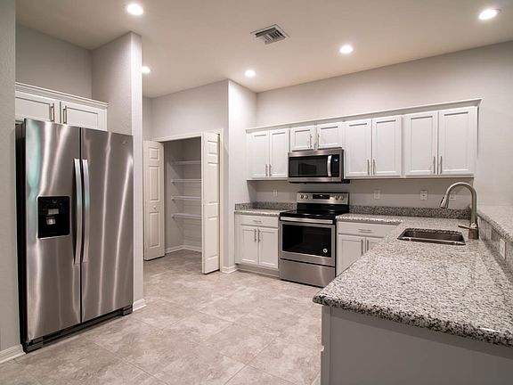 You will love the gourmet kitchen with pantry, gra