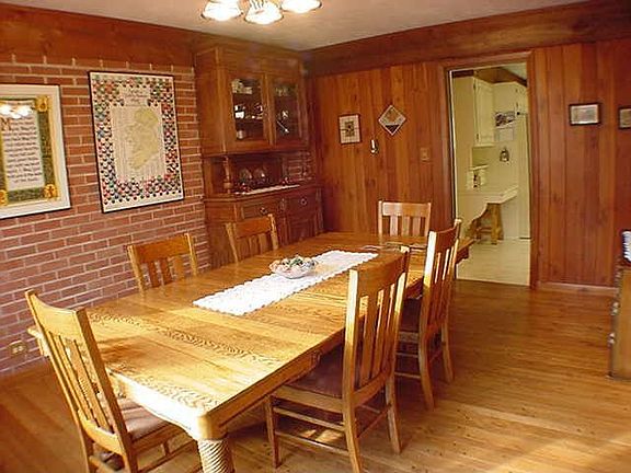 FORMAL DINING AREA WITH PLANK WOOD FLOORS AND EXPOSED BRICK WALLS!