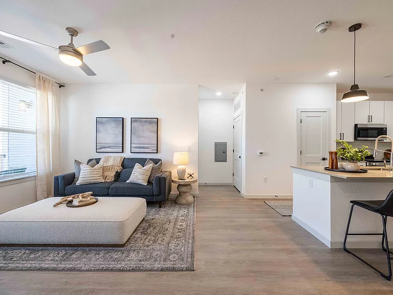 The B1 floor plan at Garrett Parker features an open layout connecting the living room, kitchen, and dining area into one continuous space.