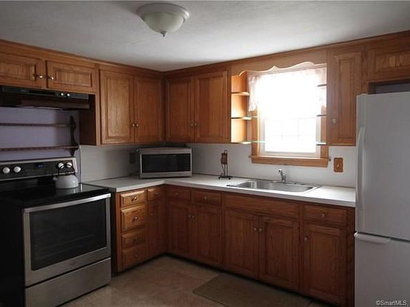 Newer stove, hood, and refrigerator.