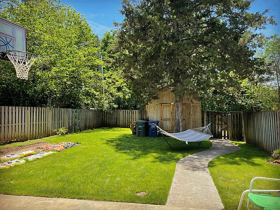 Back yard - vegetable garden - back alley access - fenced yard - outside storage room attached to house (not the barn)