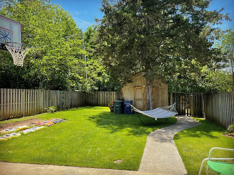 Back yard - vegetable garden - back alley access - fenced yard - outside storage room attached to house (not the barn)