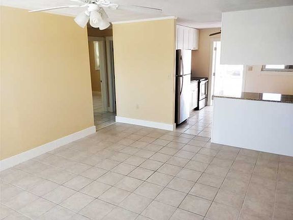 living room towards kitchen and bedrooms and bath