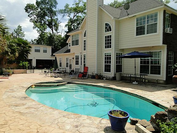 Back of home - 3 car detached garage in background.