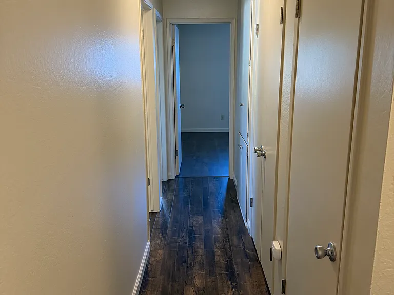 hall to bedrooms with storage cabinets