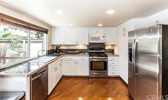 Clean, bright with white cabinets, granite counter top, SS appliances. recessed lighting