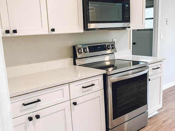 Brand new stainless steel appliances, white shaker style cabinets, and quartz countertops!