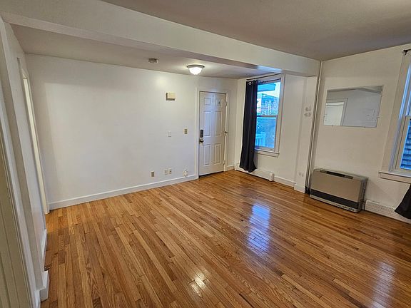 Main living area, lovely hardwood floors and high ceilings. Large windows that let in light, help keep out noise.