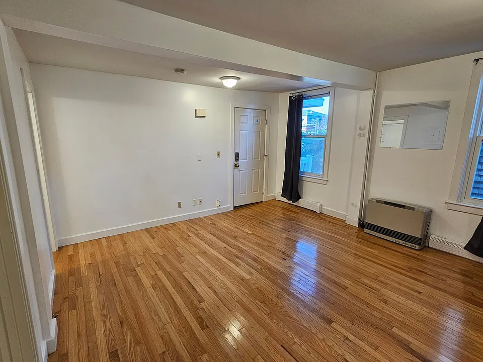 Main living area, lovely hardwood floors and high ceilings. Large windows that let in light, help keep out noise.