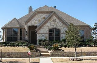 Stone elevation and extensive landscaping give home great drive up appeal. 
