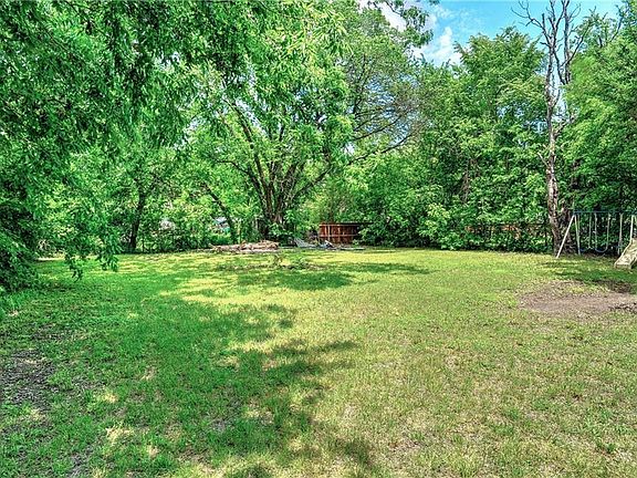 Large shady back yard is fully fenced.