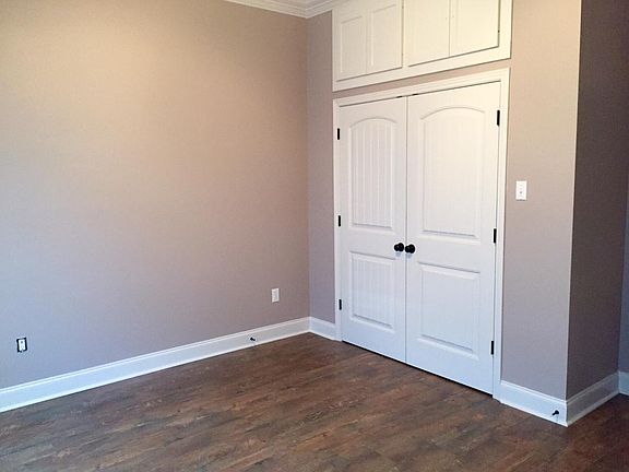Bedroom with closet and upper storage