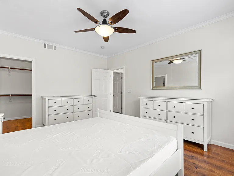King size bed with dual night stands, large walk in closet, and 2 large dressers for additional storage