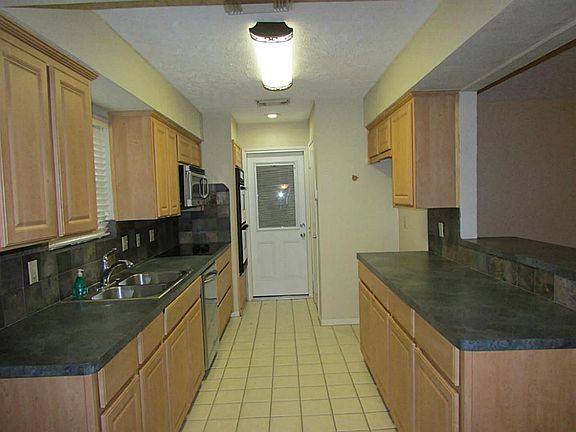 Kitchen has been remodeled and features stainless steel appliances and tile flooring.