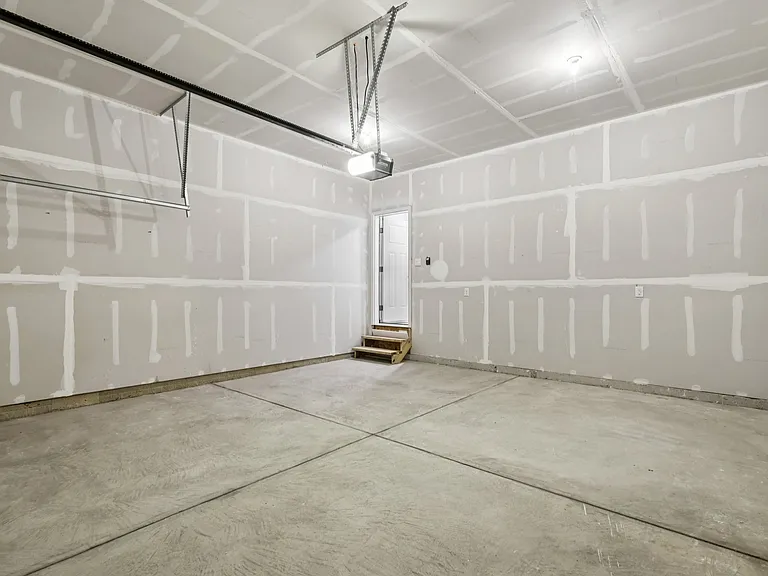 Covered two car garage with access to the First floor